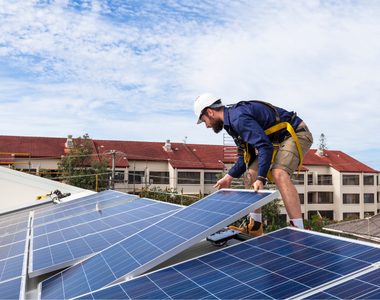 solar worker installing solar panels on a roof