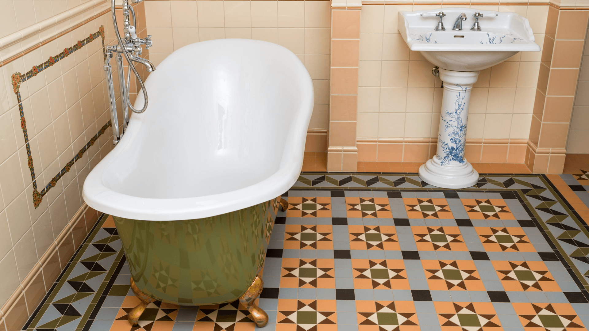 classic vintage bathroom with geometric floors and footed bath